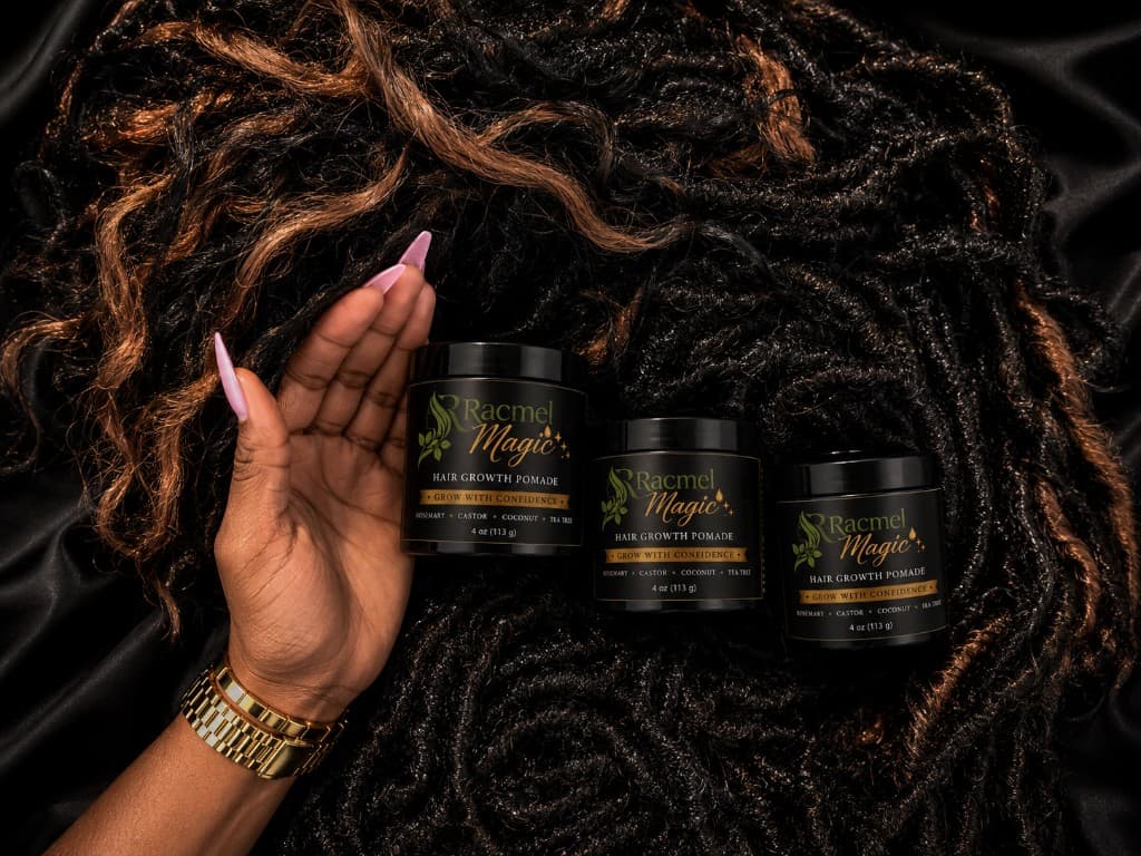 Racmel Magic pomade jars styled with locs and gold accessories